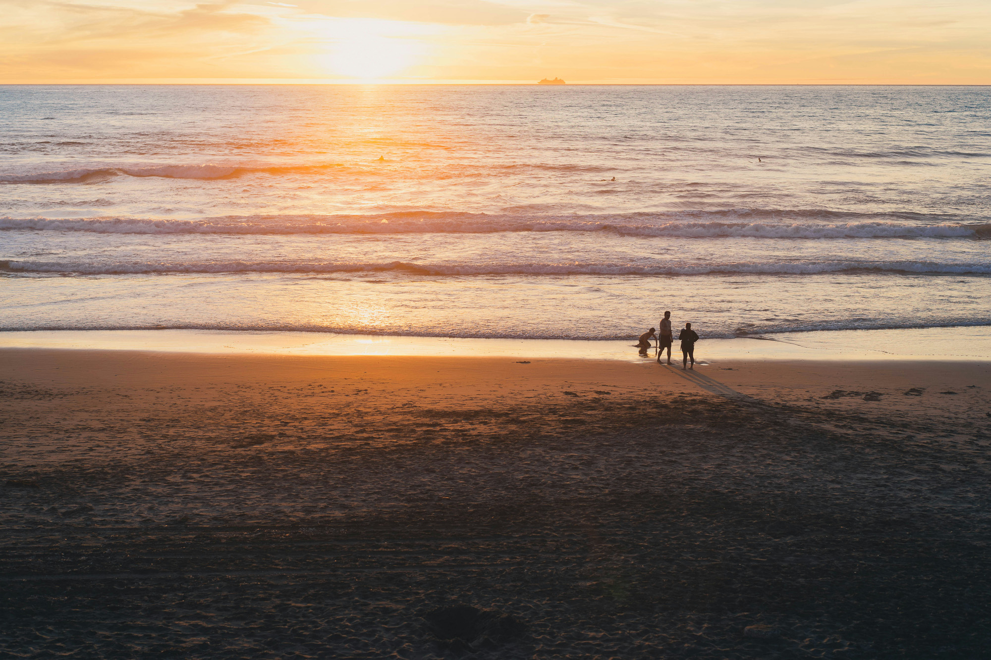 Family on Clearwater Beach at sunset — Papa Injury Law serves Clearwater car accident victims